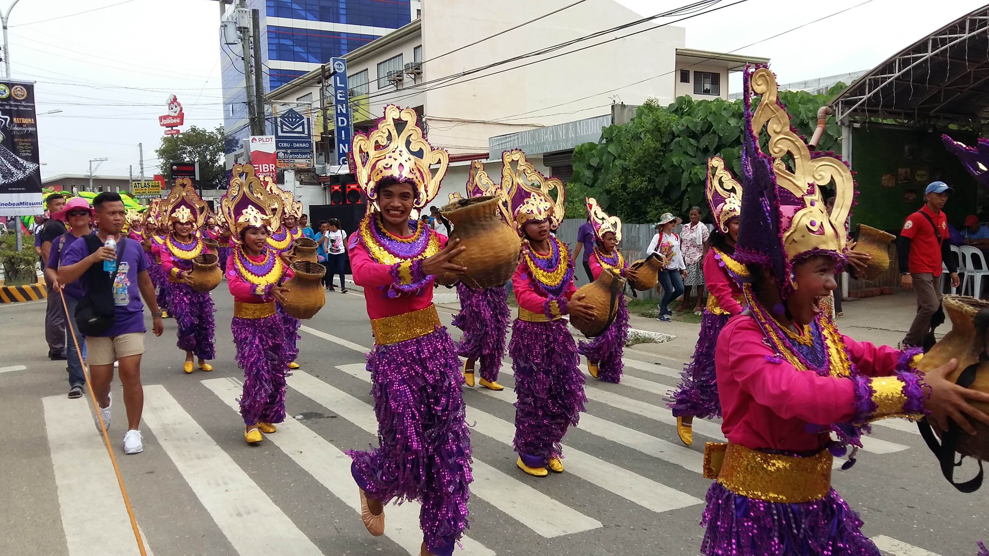 Dancers in red and gold filling a Cebu City street during the Sinulog parade
